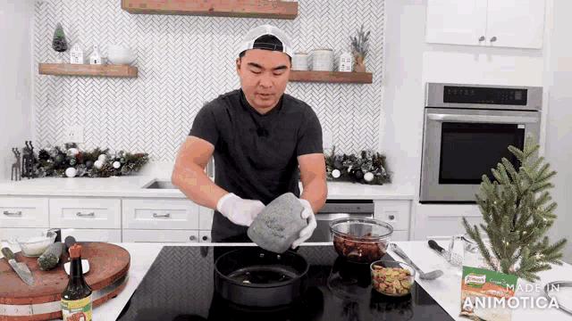 a man is cooking on a stove with a bag of knorr on the counter next to him