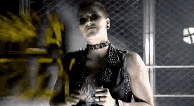 a woman wearing a choker and studded vest holds a can of soda that says vick white