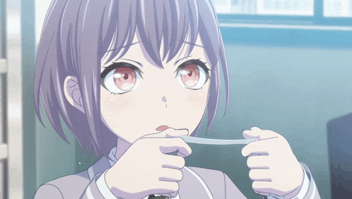 a girl with purple hair and red eyes holds something in her hands