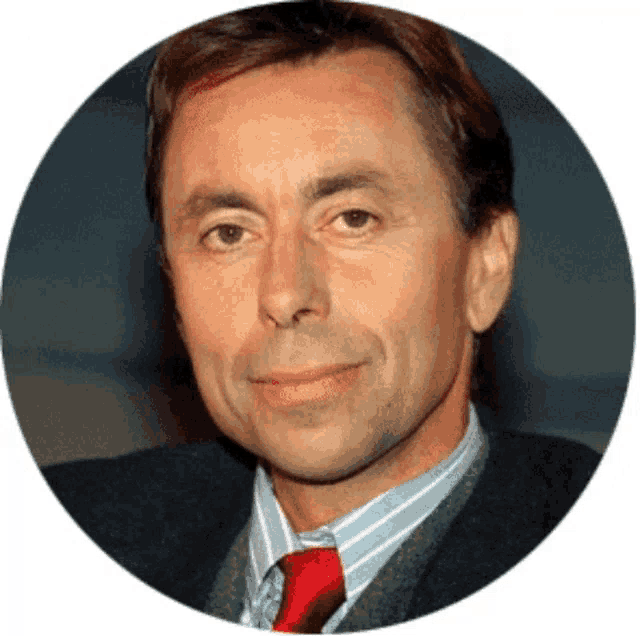 a man in a suit and tie looks at the camera in a circle
