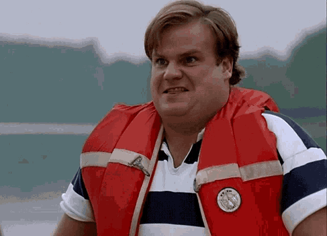 a man wearing a life jacket has a badge on his chest that says us navy