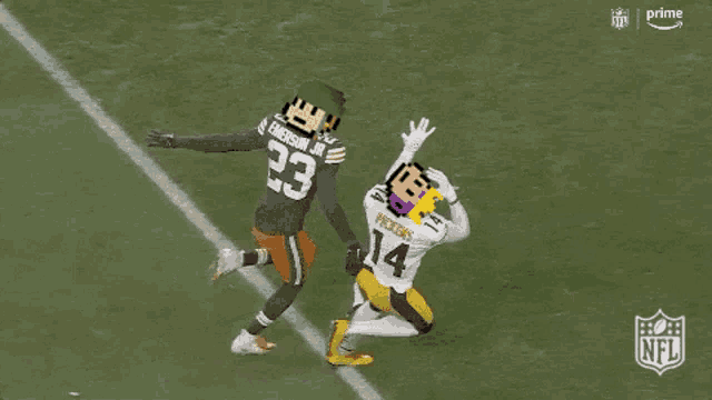 a football player with the number 23 on his jersey is being tackled by another player