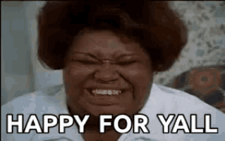 a woman is smiling and saying `` happy for yall '' while making a funny face .
