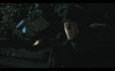 a man wearing a black cowboy hat and a black coat