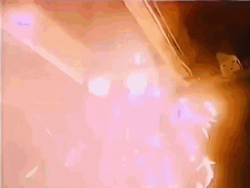 a close up of a person 's arm with a purple light coming out of it