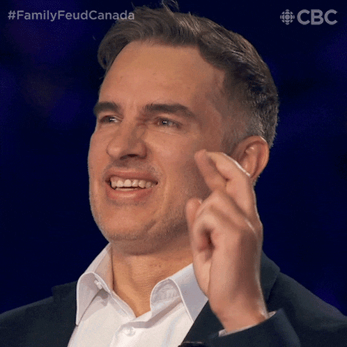a man in a suit and white shirt is making a funny face with the hashtag familyfeudcanada