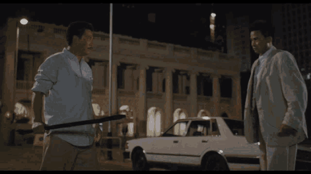 a man in a suit and tie is kicking another man