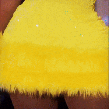 a close up of a person wearing a yellow fur skirt