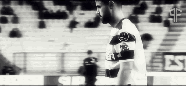 a black and white photo of a soccer player wearing a white jersey with the number 17 on the sleeve