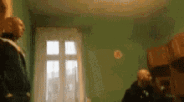 a blurry picture of people standing in a room with a window