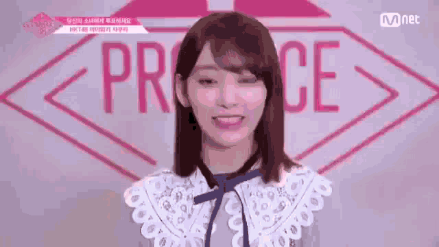 a young woman is smiling in front of a sign that says ' princess ' on it .