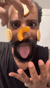 a man with crackers on his face making a face with his tongue out