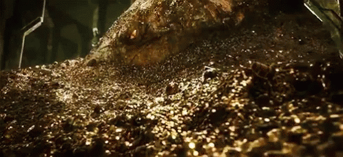 A large dragon, Smaug from the Hobbit movies, raises its head slowly from an immense pile of treasure, mostly gold coins. 