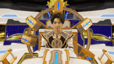a man is sitting in a throne with the letter i on the table