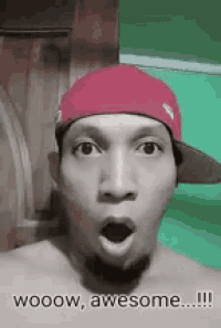 a shirtless man wearing a red hat is making a surprised face