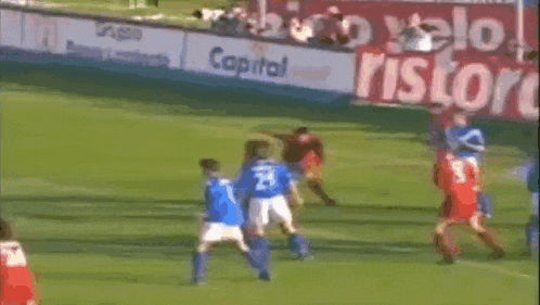 a group of soccer players are playing on a field with a sign that says capital ristor