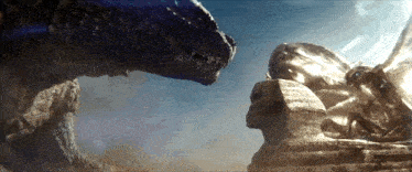 two monsters are standing next to each other in front of a sphinx