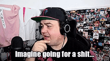 a man wearing headphones and a hat says " imagine going for a shit ... "