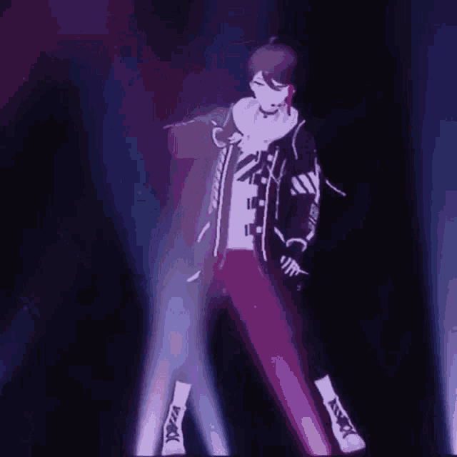 a person is standing on a stage in front of a microphone .