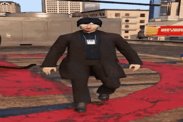 a man in a suit is walking on a red carpet in front of a sign that says mighty empire