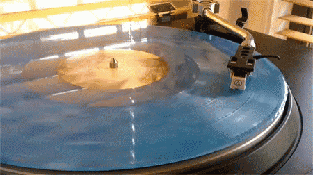a record player is playing a blue vinyl record
