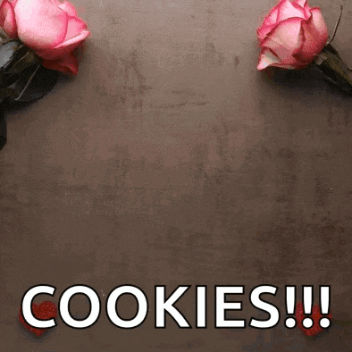 two pink roses on a table with the words cookies !!!