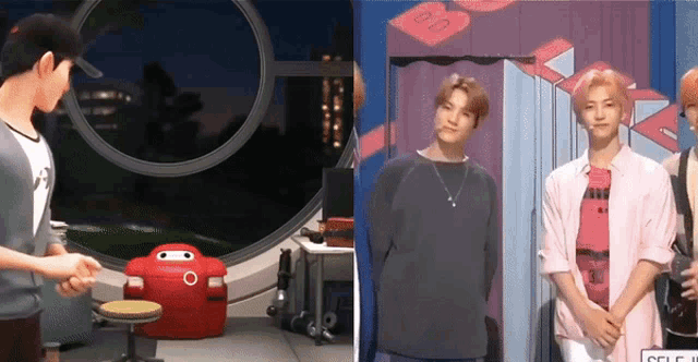 a man in a pink shirt is standing next to a red robot