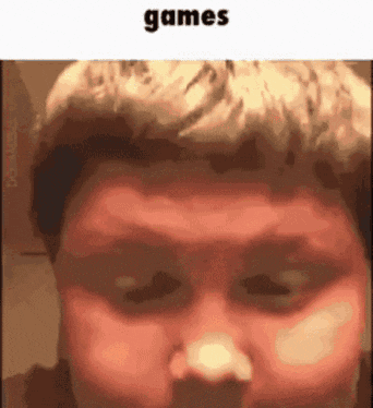 a close up of a person 's face with the words `` games '' written on the bottom .