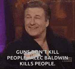 a man is laughing and covering his mouth with his hand while talking about guns .