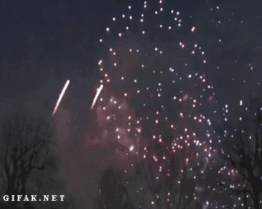 two fireworks are displayed in the night sky and the website gifak.net is displayed below them