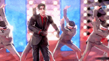a man in a suit is dancing with a group of people