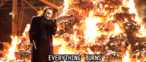the joker is standing in front of a pile of burning barrels with the words everything burns above him