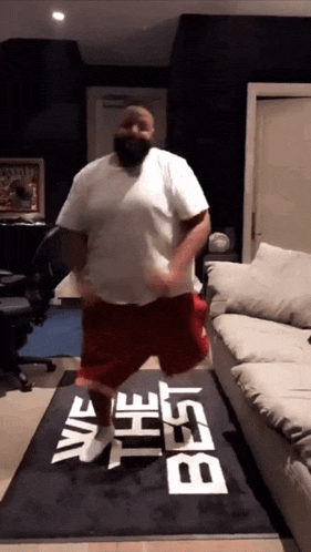 a man is dancing on a rug that says " we the best "