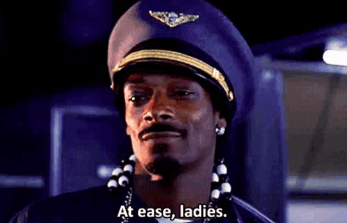 snoop dogg is wearing a pilot 's hat and talking about ladies .