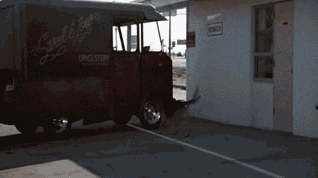 a black van that says sweet joy upholstery on it