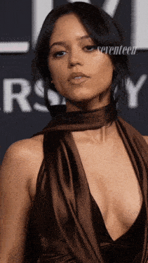 a woman in a very plunging neckline dress with seventeen written on the bottom right