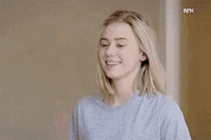 a young woman is giving the middle finger .