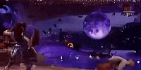 a group of people are dancing on a stage in front of a pool at night .