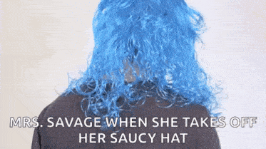 a woman wearing a blue wig and a black shirt is talking to someone .