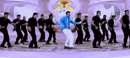 a group of men are dancing on a stage in a circle .