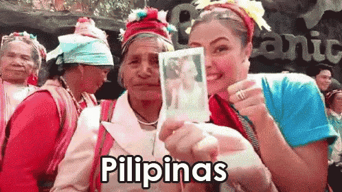 a woman is holding a picture of another woman and the word pilipinas is on the bottom right