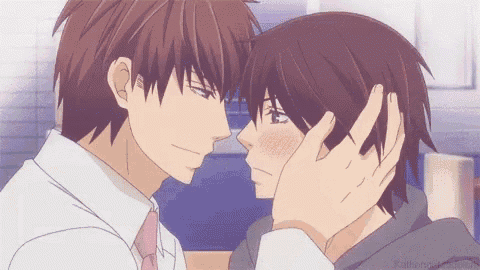 two anime characters are touching each other 's faces in a room .