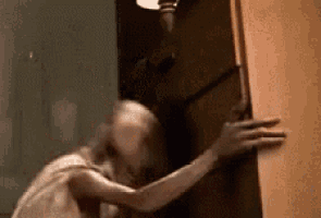 a close up of a person holding a door in a room .
