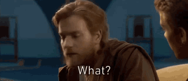 a man with a beard is talking to another man in a room and asking what .
