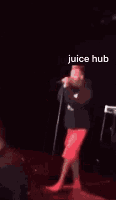 a blurred image of a person in a red hat