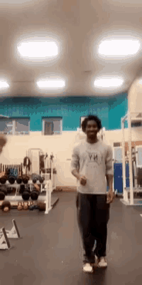 a man in a gym wearing a shirt that says ' ym ' on it