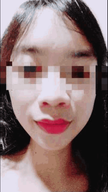 a close up of a woman 's face with a pixelated face .