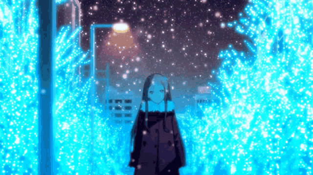 a girl is standing in the snow in front of a christmas tree with blue lights .