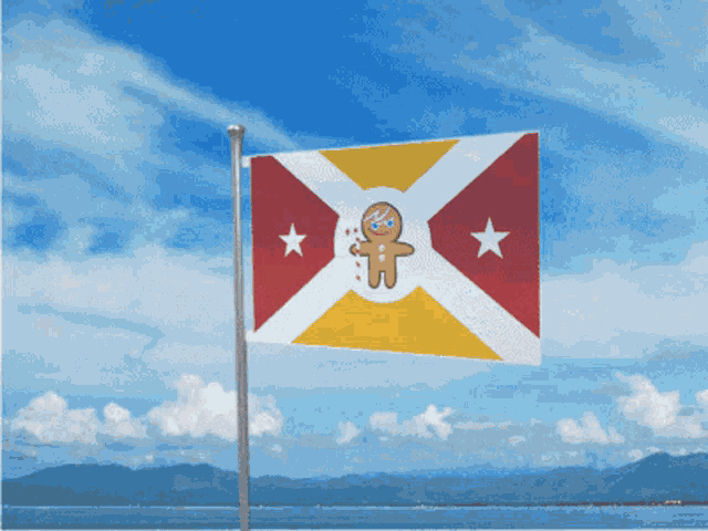 a flag with a gingerbread man on it is flying in the wind