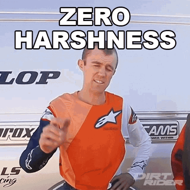 a man wearing an orange and white shirt with the words zero harshness on it